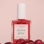 Active Glow™ Cranberry buteliukas su koraliniu atspalviu spanguolės fone